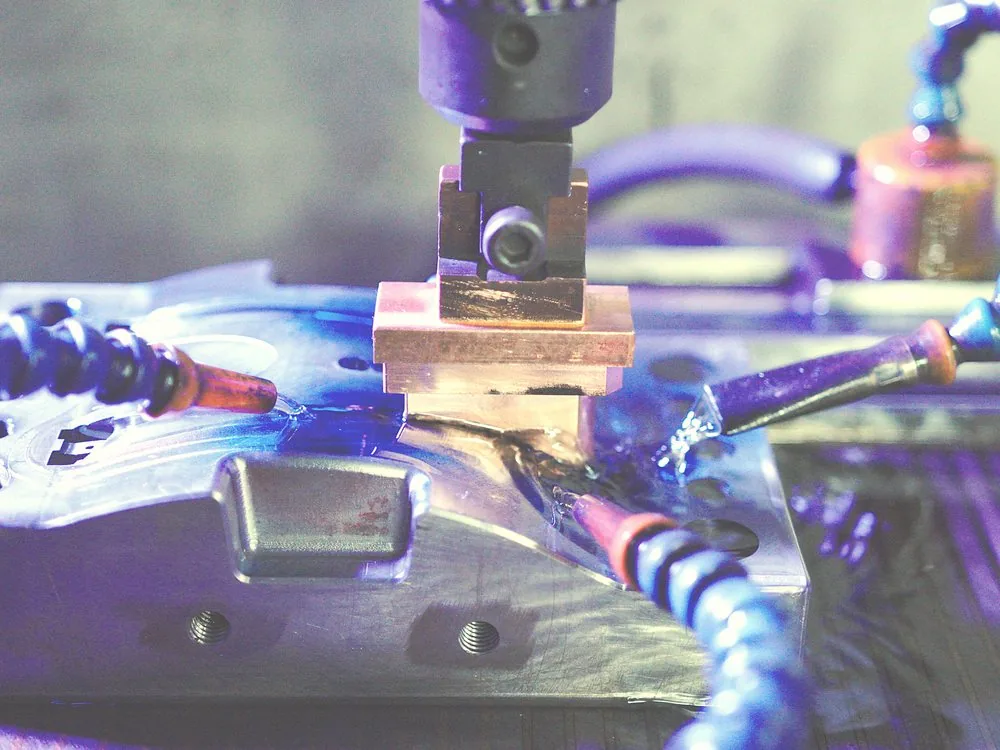 EDM sinking a copper electrode into a mold plate