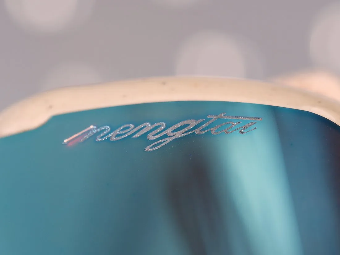 Brand mark laser etched into a mirrored lens